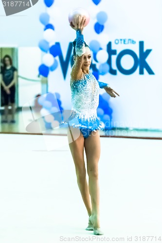 Image of Young beautiful girl shows exercise with ball