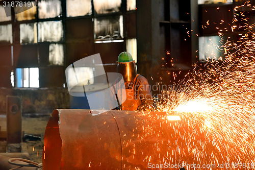 Image of Welder uses torch