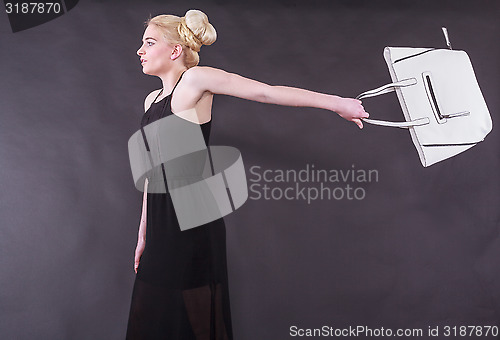 Image of spirited young blond woman with purse