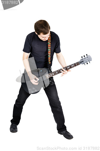 Image of young man with an electric guitar. Isolated
