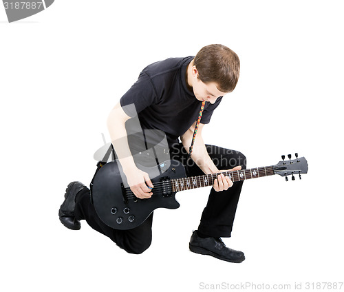 Image of young man with an electric guitar. Isolated