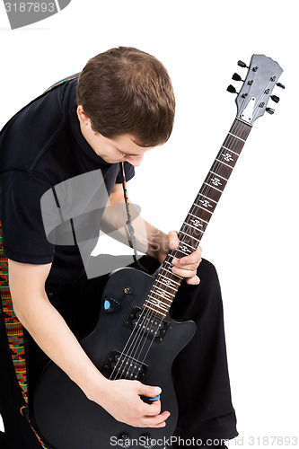Image of young man with an electric guitar. Isolated
