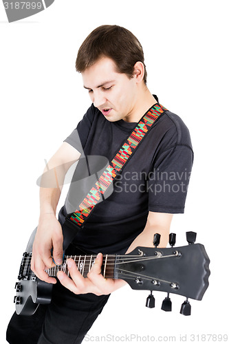 Image of young man with an electric guitar. Isolated