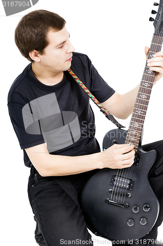 Image of young man with an electric guitar. Isolated