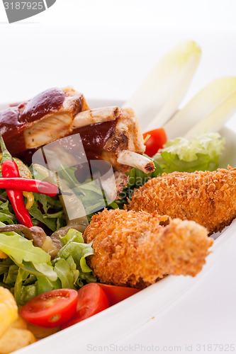 Image of Platter of mixed meats, salad and French fries