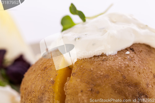 Image of Baked jacket potato with sour cream sauce
