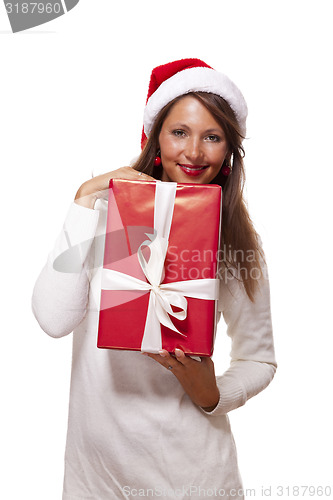 Image of Pretty woman in a Santa hat with a large gift