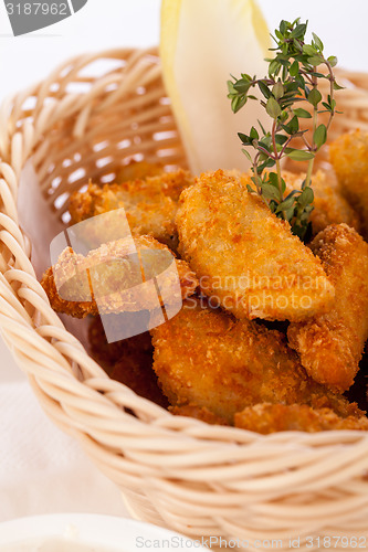 Image of Crumbed chicken nuggets in a basket