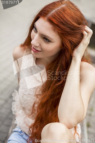 Image of Pretty Blond Woman Sitting on Red Chair