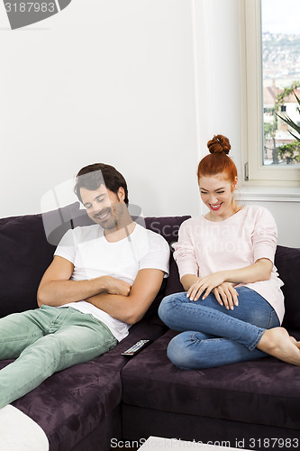 Image of Happy Young Sweet Couple Sitting at the Couch