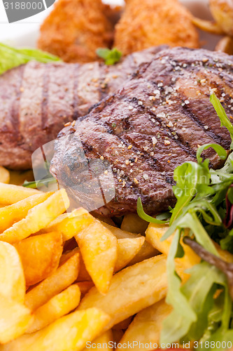 Image of Platter of mixed meats, salad and French fries