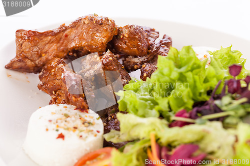 Image of grilled beef stripes fresh salad and goat cheese