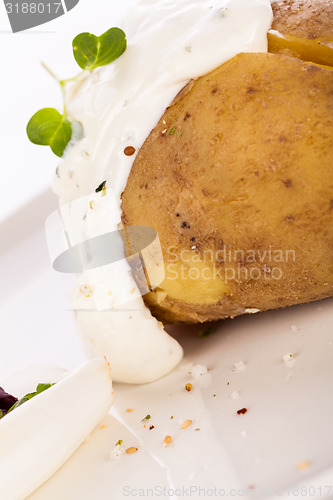 Image of Baked jacket potato with sour cream sauce