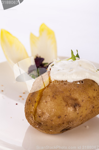 Image of Baked jacket potato with sour cream sauce