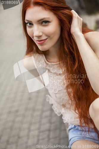 Image of Pretty Blond Woman Sitting on Red Chair