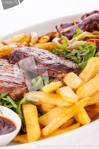 Image of Platter of mixed meats, salad and French fries