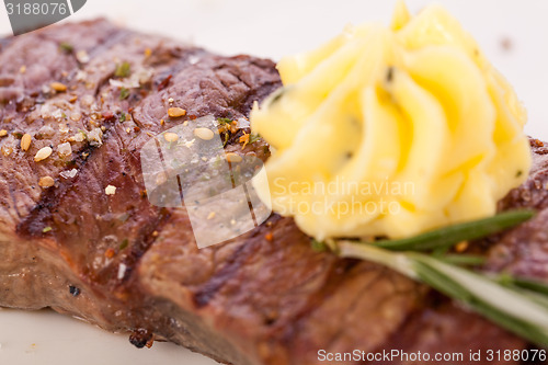 Image of Grilled beef steak topped with butter and rosemary