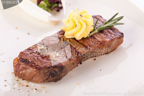 Image of Grilled beef steak topped with butter and rosemary
