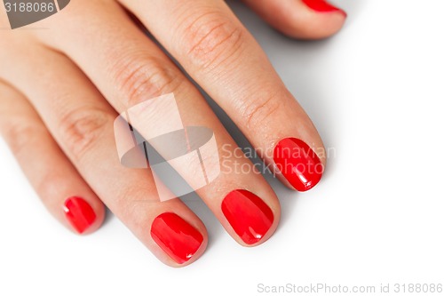 Image of Woman with beautiful manicured red fingernails