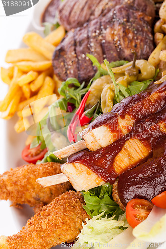 Image of Platter of mixed meats, salad and French fries