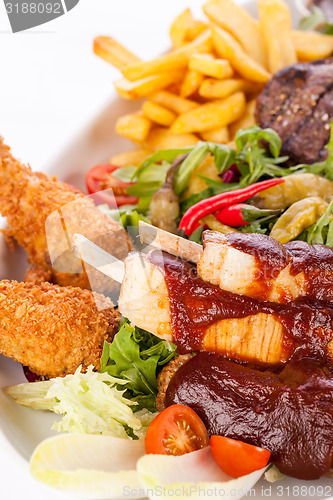 Image of Platter of mixed meats, salad and French fries