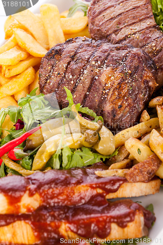 Image of Platter of mixed meats, salad and French fries