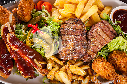 Image of Platter of mixed meats, salad and French fries