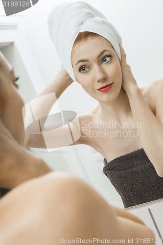 Image of Woman From Shower Looking her Face at the Mirror
