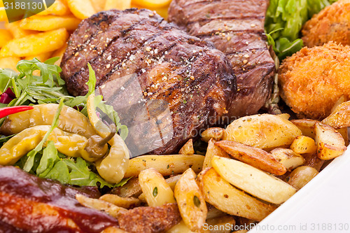 Image of Platter of mixed meats, salad and French fries