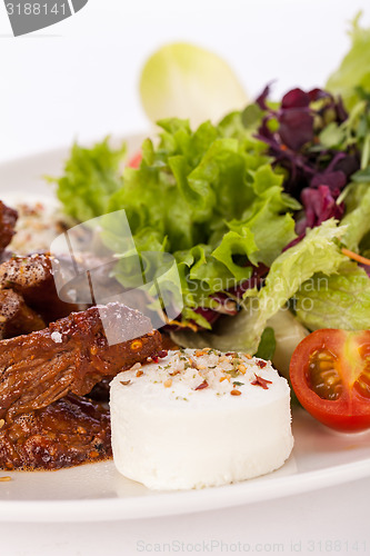 Image of grilled beef stripes fresh salad and goat cheese