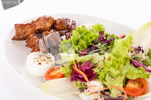 Image of grilled beef stripes fresh salad and goat cheese