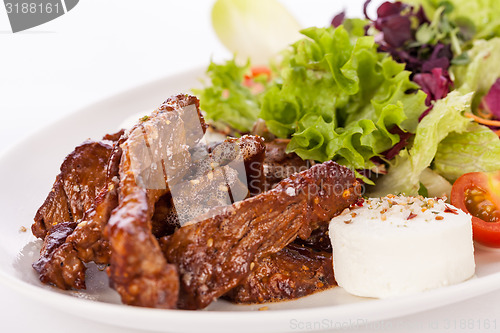 Image of grilled beef stripes fresh salad and goat cheese