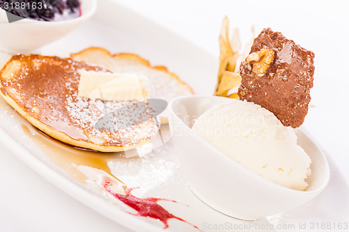 Image of tasty sweet pancakes with vanilla icecream and topping