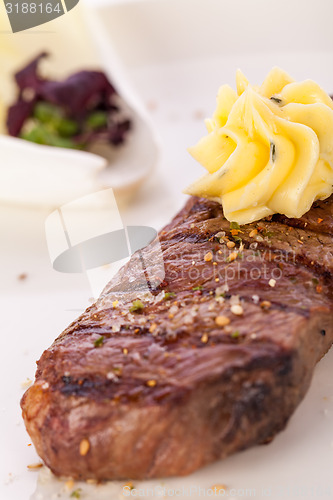 Image of Grilled beef steak topped with butter and rosemary