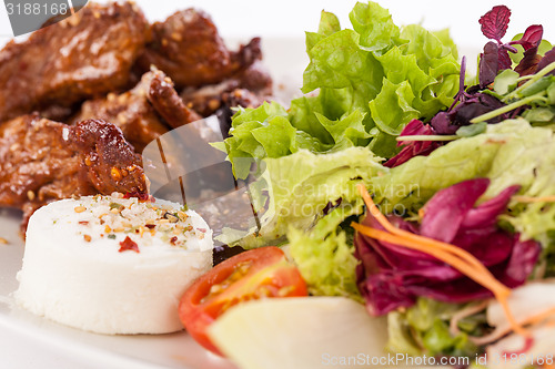 Image of grilled beef stripes fresh salad and goat cheese