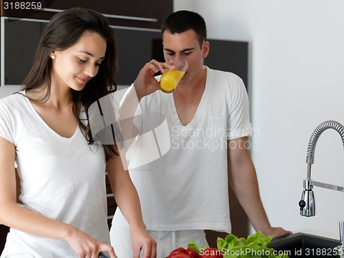 Image of happy young couple in kicthen