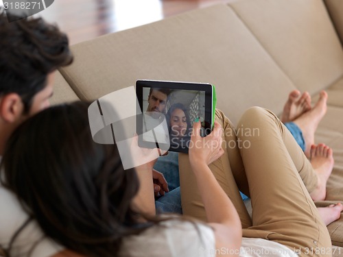 Image of young couple making selfie together at home