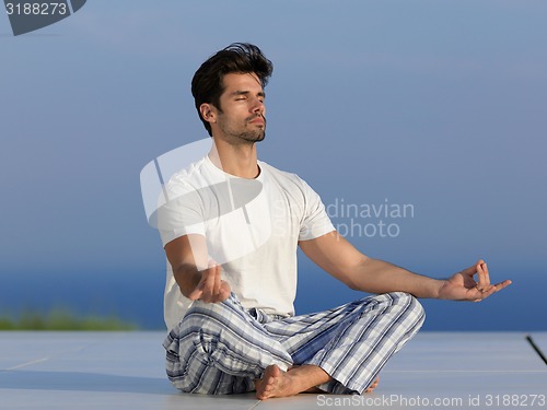 Image of young man practicing yoga