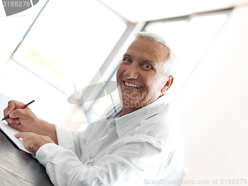 Image of Portrait of senior man relaxing in sofa