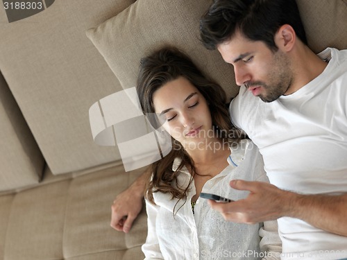 Image of young couple making selfie together at home