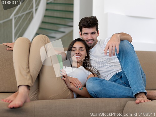 Image of young couple making selfie together at home