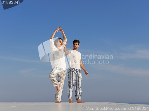 Image of young couple practicing yoga