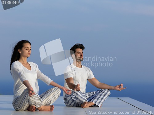 Image of young couple practicing yoga