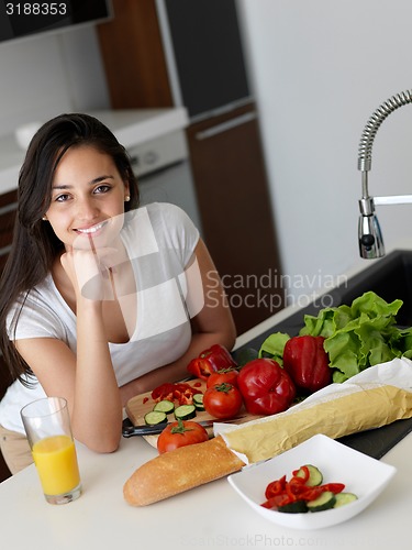 Image of Young Woman Cooking in the kitchen