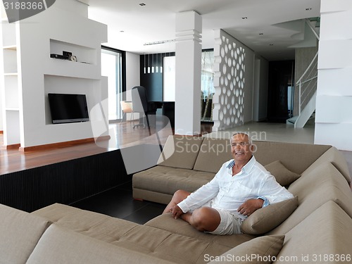 Image of Portrait of senior man relaxing in sofa