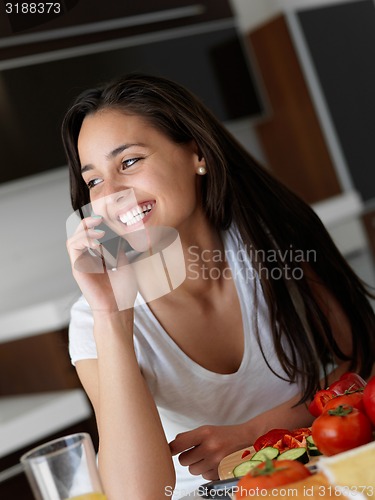 Image of Young Woman Cooking in the kitchen