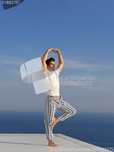 Image of young man practicing yoga