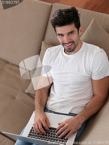 Image of Man Relaxing On Sofa With Laptop