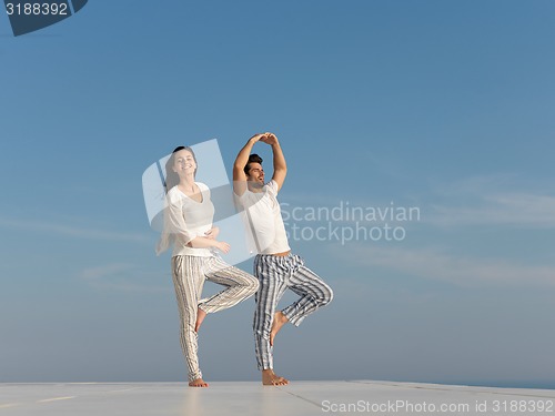 Image of young couple practicing yoga