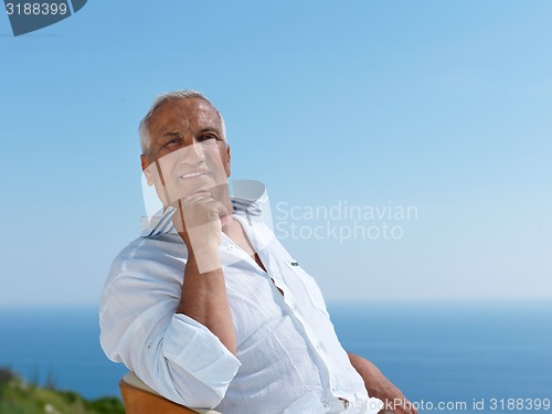 Image of senior man sitting outside